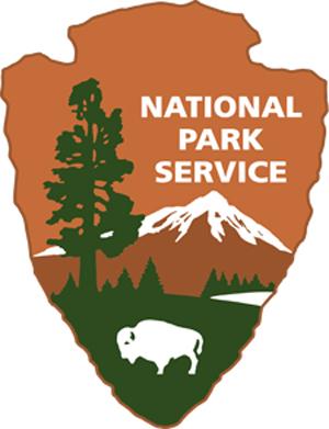 The words "NATIONAL PARK SERVICE" read across a silhouette of an arrowhead. 